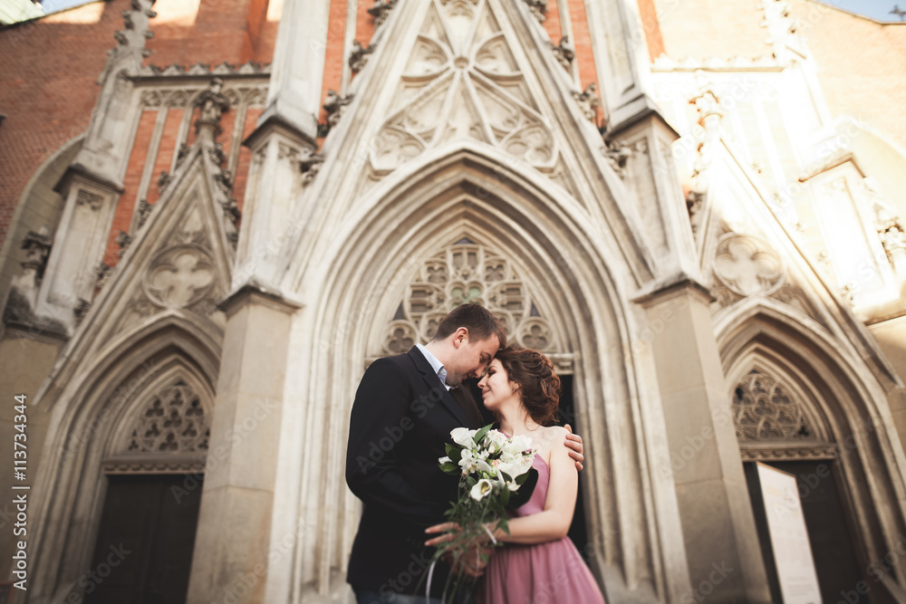 Elegant beautiful wedding couple posing near a church. Krakow