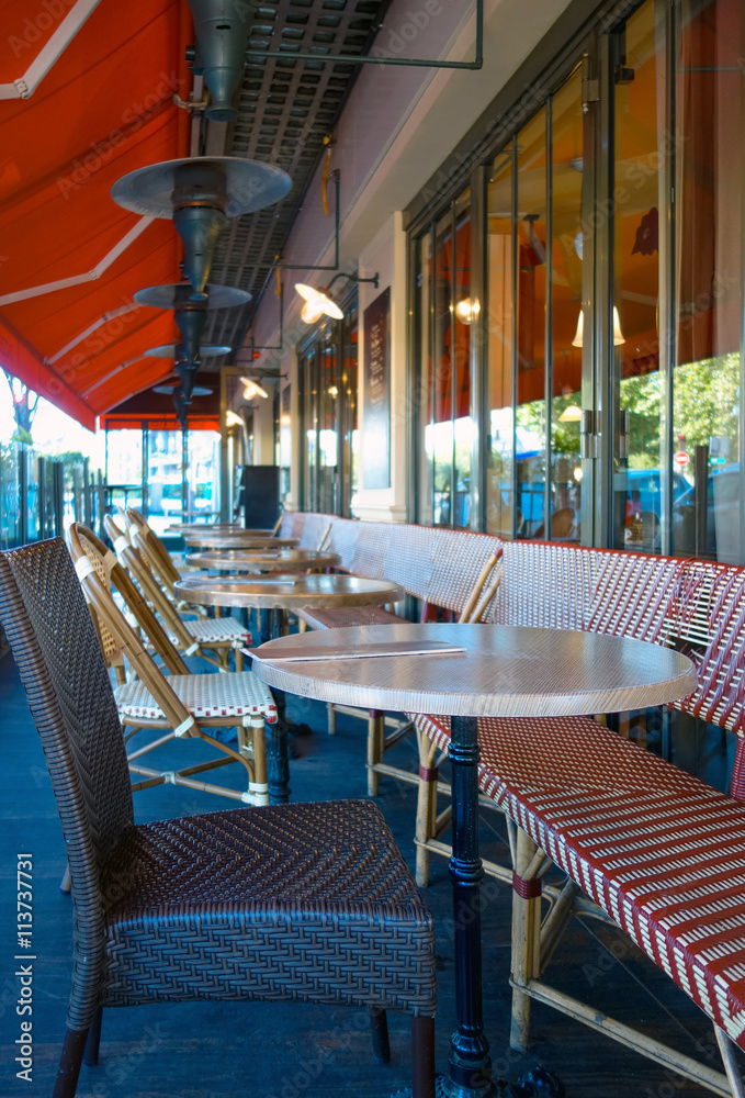Fototapeta premium Street view of a coffee terrace with tables and chairs in europe