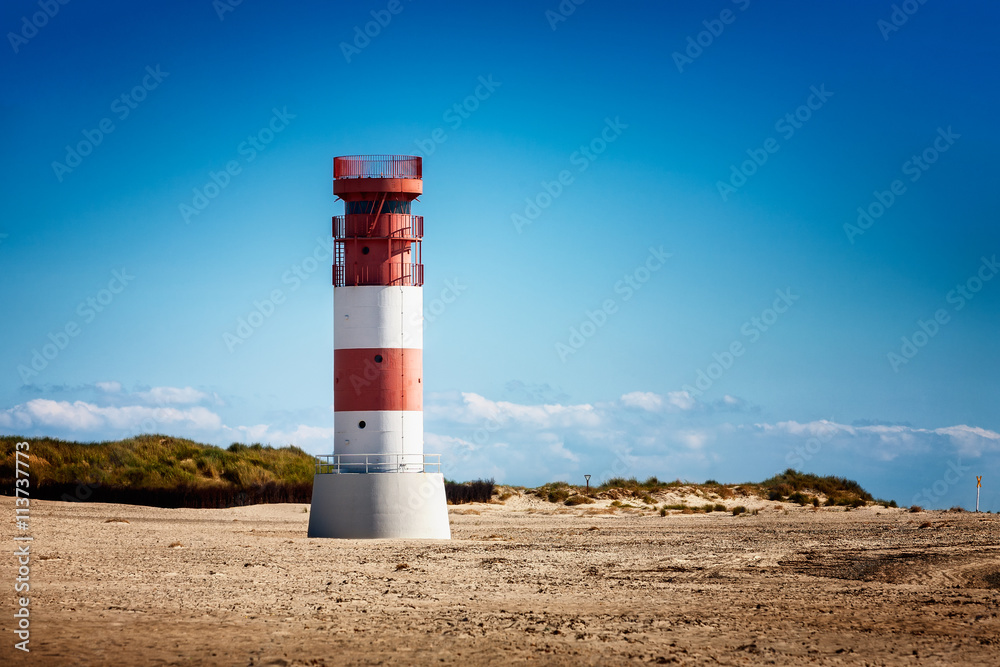 Lighthouse on dunes beach