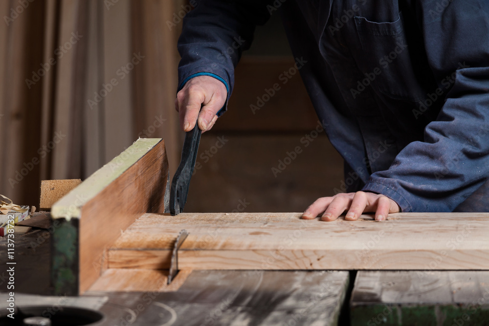 Carpenter's hands cutting wood board with Table Saw Carpenter's hands cutting wood board with Table Saw