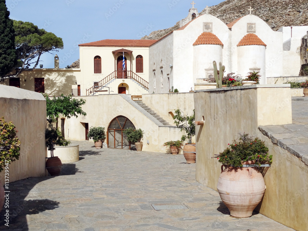 traditional old monastery among bougainvillaea in Greece
