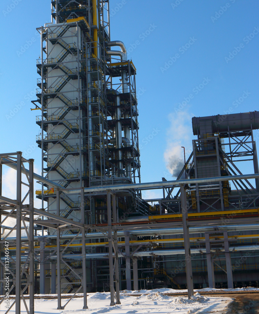 Modern oil refinery factory (petroleum refinery) against a blue sky