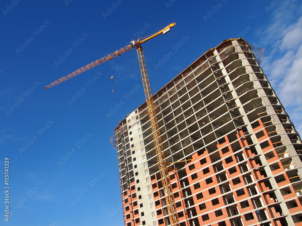 Wall construction crane on a sky background