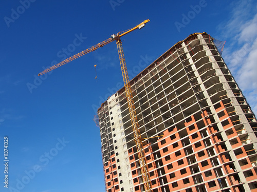 Wall construction crane on a sky background