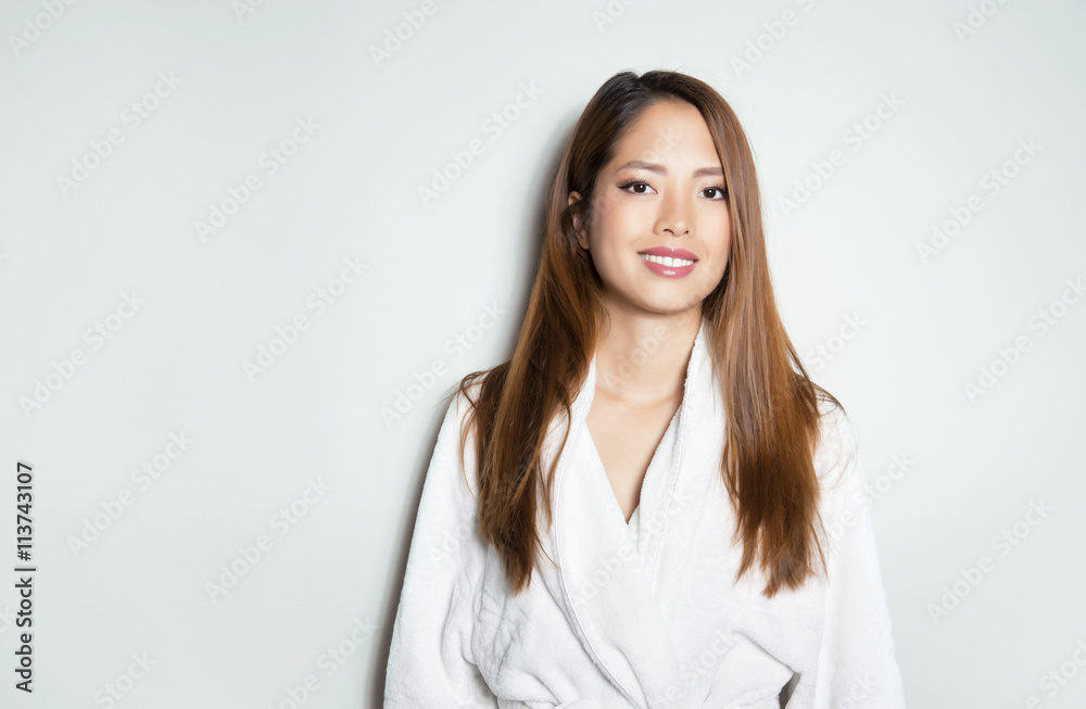 beautiful, happy young woman with flawless skin and long hair posing in bath robe beautiful, happy young woman with flawless skin and long hair posing in bath robe