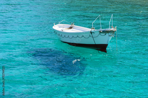 White boat in sea waters near island © vivoo