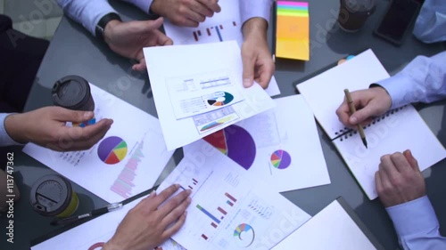 Business chart is placed on the table.