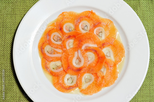 image of raw and fresh salmon sliced topped on ice in dish