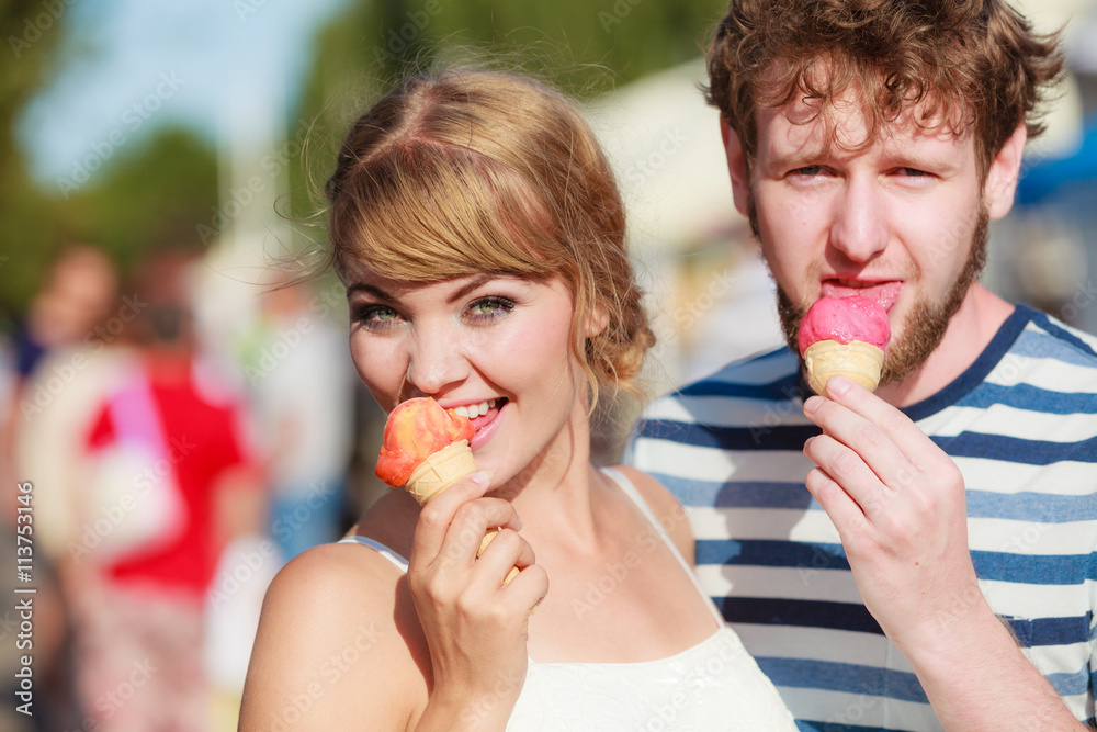 young couple eating ice cream outdoor