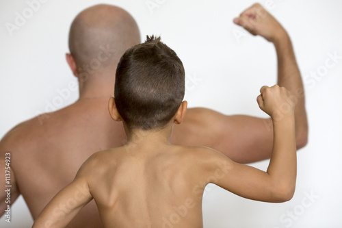 Father and son show muscles