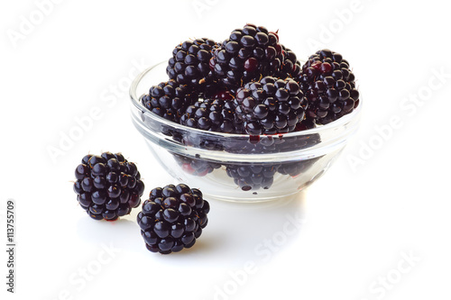 Glass bowl with blackberries on white