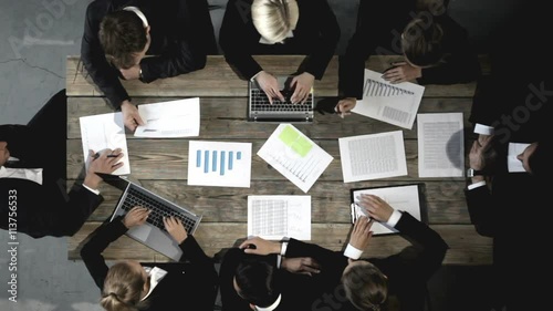 Business people discussing the charts and graphs showing the results of their successful teamwork