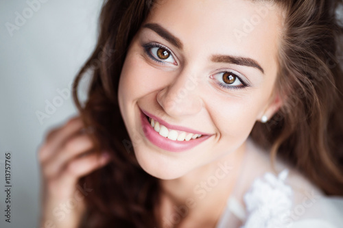 Portrait of smiling woman with perfect smile and white teeth looking at camera