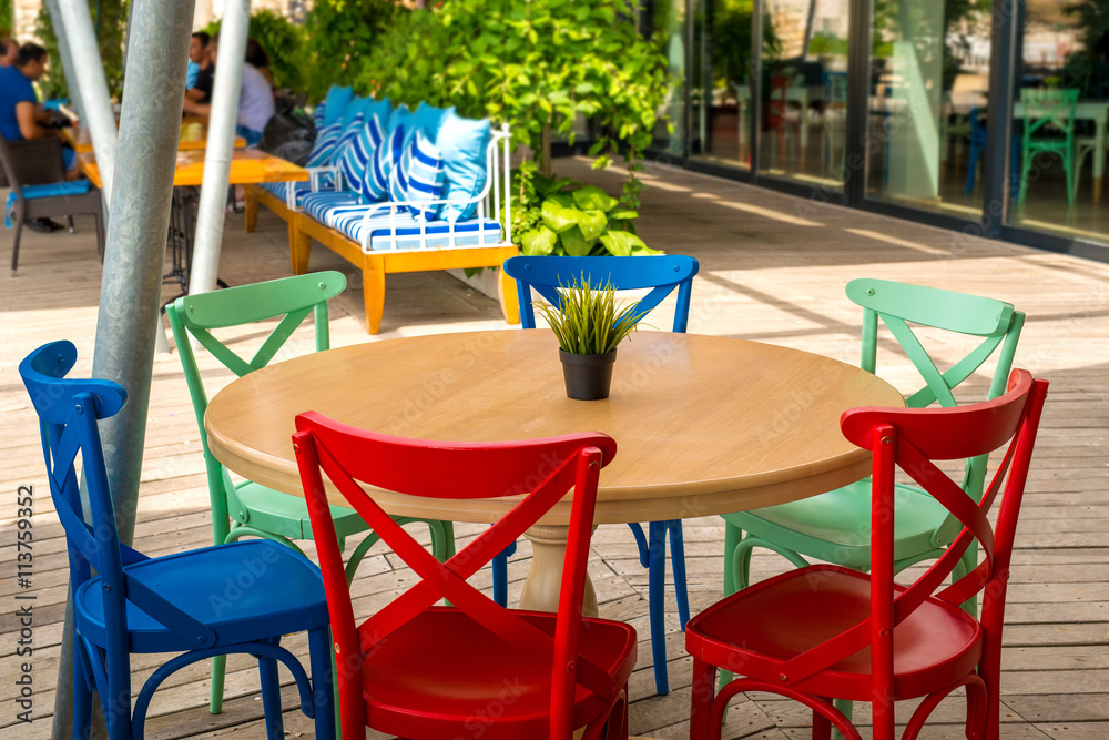 Fototapeta premium table and colorful chairs in a restaurant