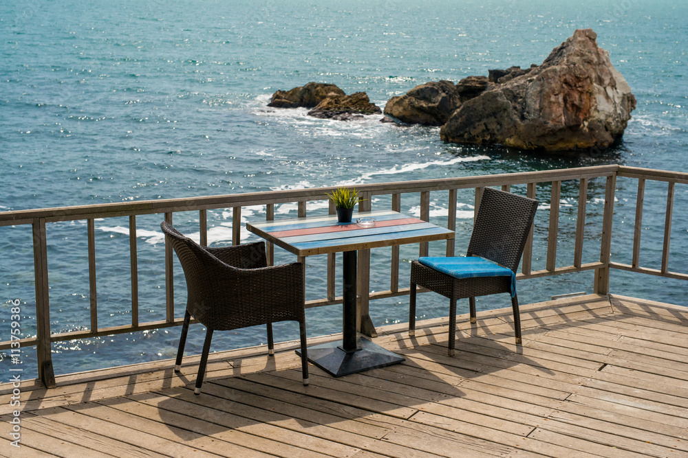 Romantic table for two people on a terrace by the sea