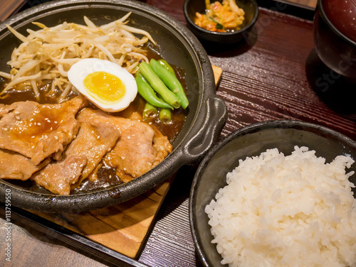 pork with egg and vegetables on hot plate