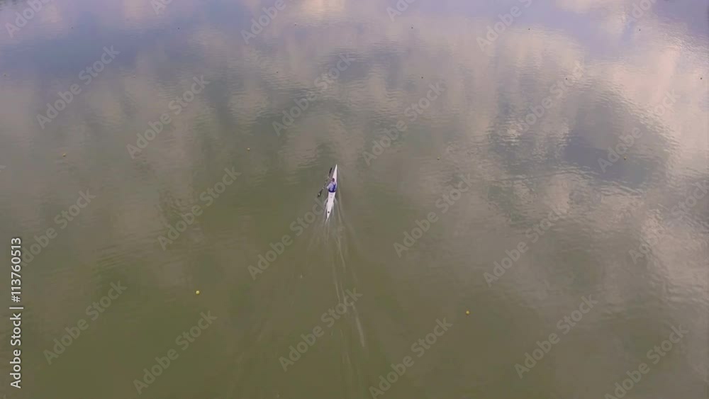 Aerial view of a person kayaking in artificial lake Aerial view of a person kayaking in artificial lake