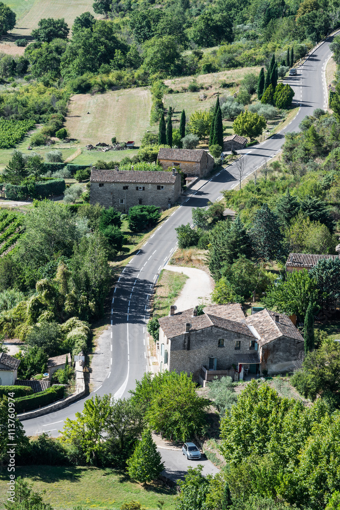 Modern twisted asphaltic road across a small village of Provence