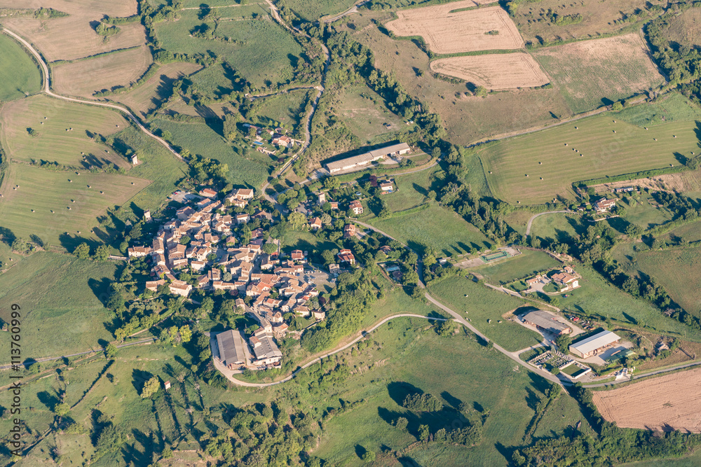 Birds eye view of cultivated land, roads and private houses