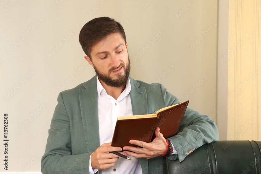 successful business man in the office is studying the diary successful business man in the office is studying the diary