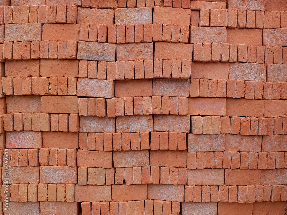 Bricks made from clay and burnt arranged neatly for easy counting before transport to be used in construction. Bricks made from clay and burnt arranged neatly for easy counting before transport to be used in construction.