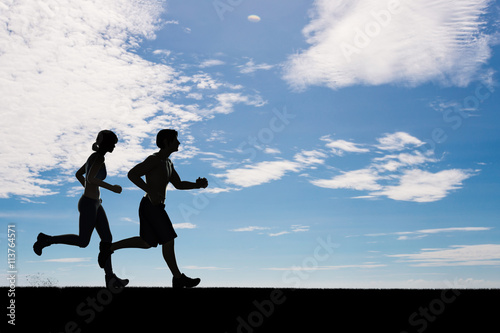 silhouette man and woman running