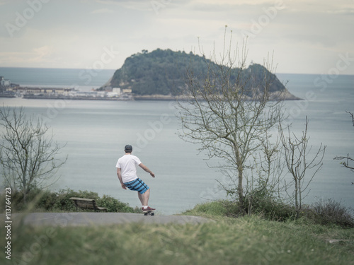 man skateboarding downhill
