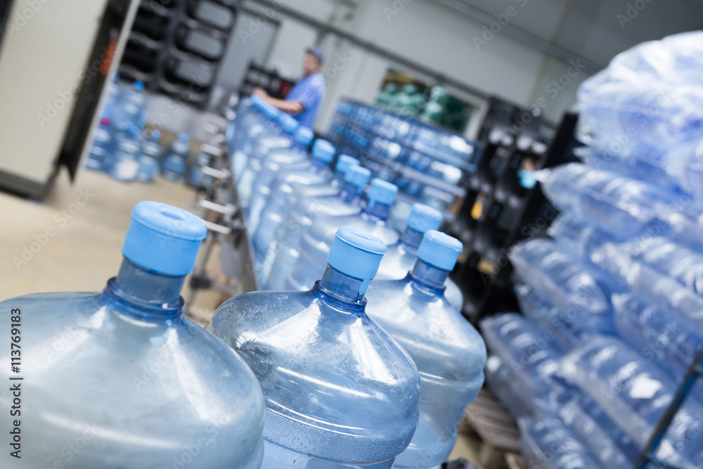 Robotic factory line for processing and bottling pure spring water into gallons. Short depth of field and selective focus. Robotic factory line for processing and bottling pure spring water into gallons. Short depth of field and selective focus.