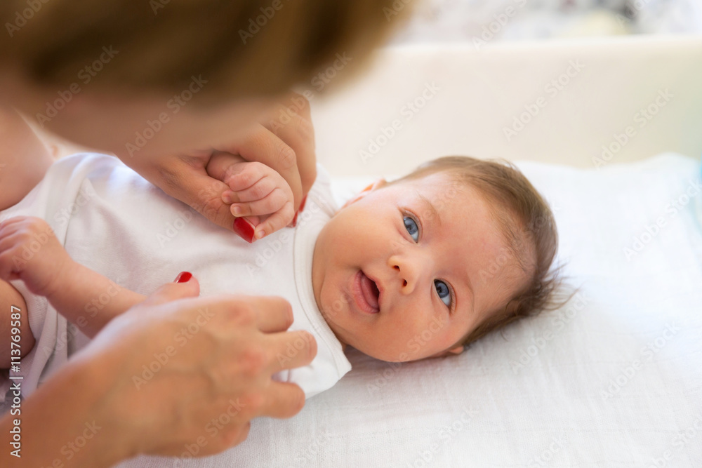 Two months old baby girl smiling with mother. Two months old baby girl smiling with mother.
