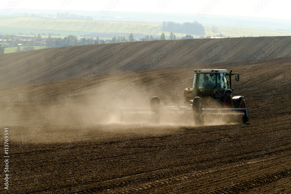 Naklejka premium Agricultural tractor working