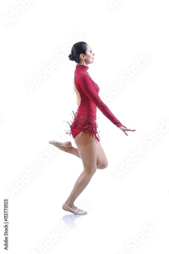 Beautiful artistic female gymnast working out, performing art gymnastics element