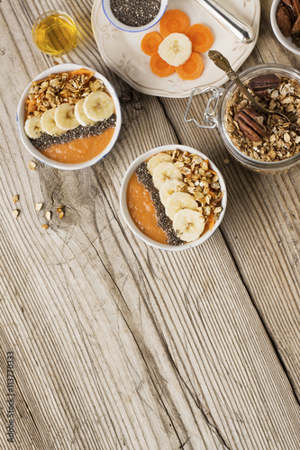 Healthy breakfast. Carrot Banana smoothie with granola and chia seeds