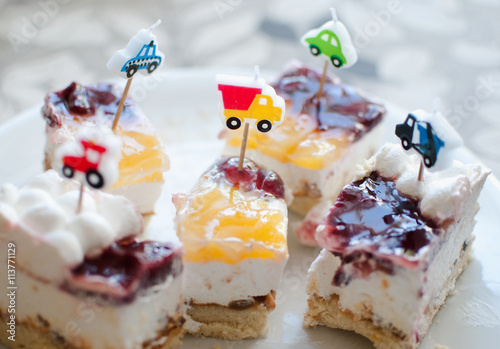 Sweet delicious cakes and bright cars candles photo