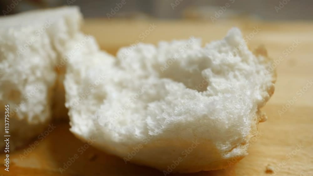 Torn soft wheat bread, dolly shit macro video with racking focus
