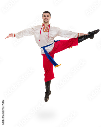 young man wearing a folk costume jumping against isolated white with copyspace photo