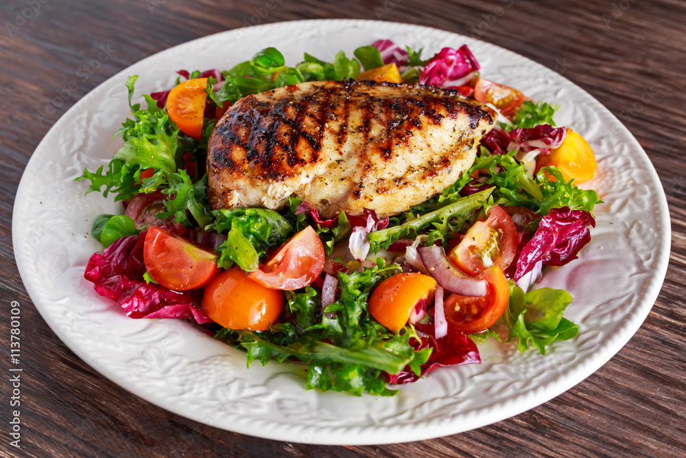 Grilled Chicken Breast fillet with fresh tomatoes vegetables salad. concept healthy food. Grilled Chicken Breast fillet with fresh tomatoes vegetables salad. concept healthy food.