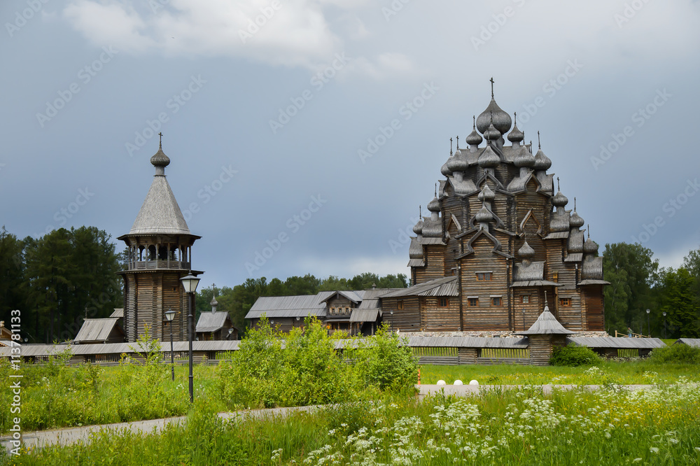 Fototapeta premium The wooden Church of the Intercession of the Holy virgin - active Orthodox temple in the Nevsky forest Park of Vsevolozhsk district of Leningrad region. Copy of Russian wooden Architecture.