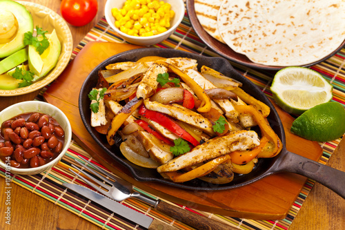 Fotografi Chicken Fajitas with Grilled Onions and Bell Peppers serve with Tortillas