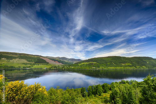 Beautiful Reflections Over Loch Tay, Scotland. Mountains in the background. A summers day.