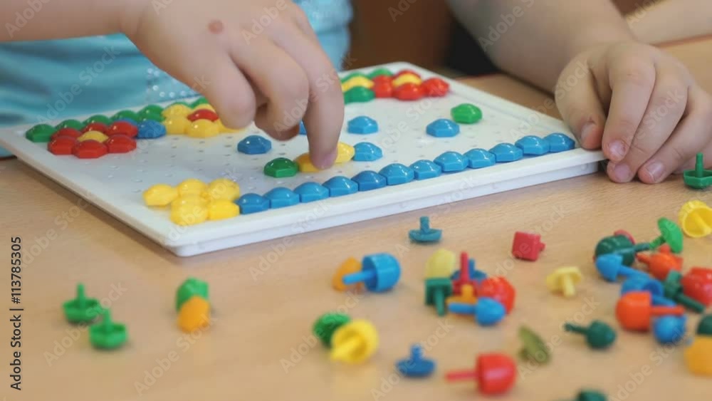 Little girl plays a intellectual educational game