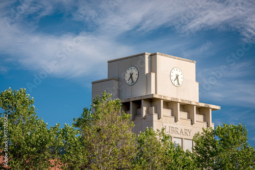Library clock towers with clouds and trees