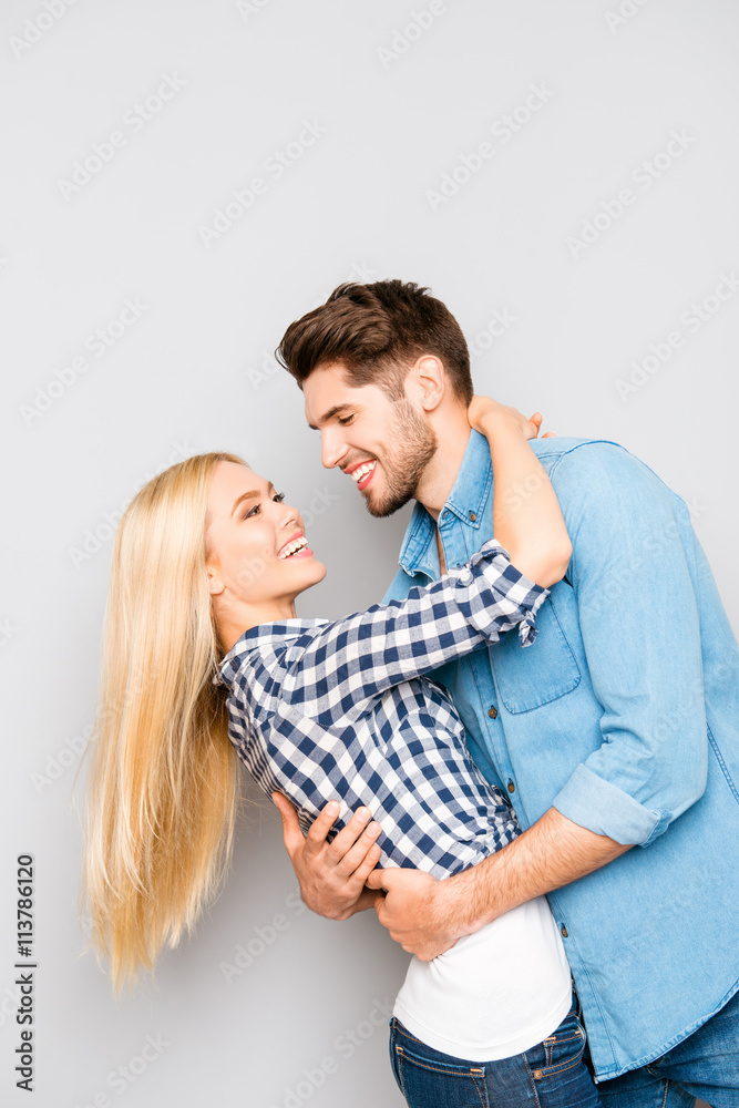 Portrait of happy cheerful smiling man and woman huging Portrait of happy cheerful smiling man and woman huging
