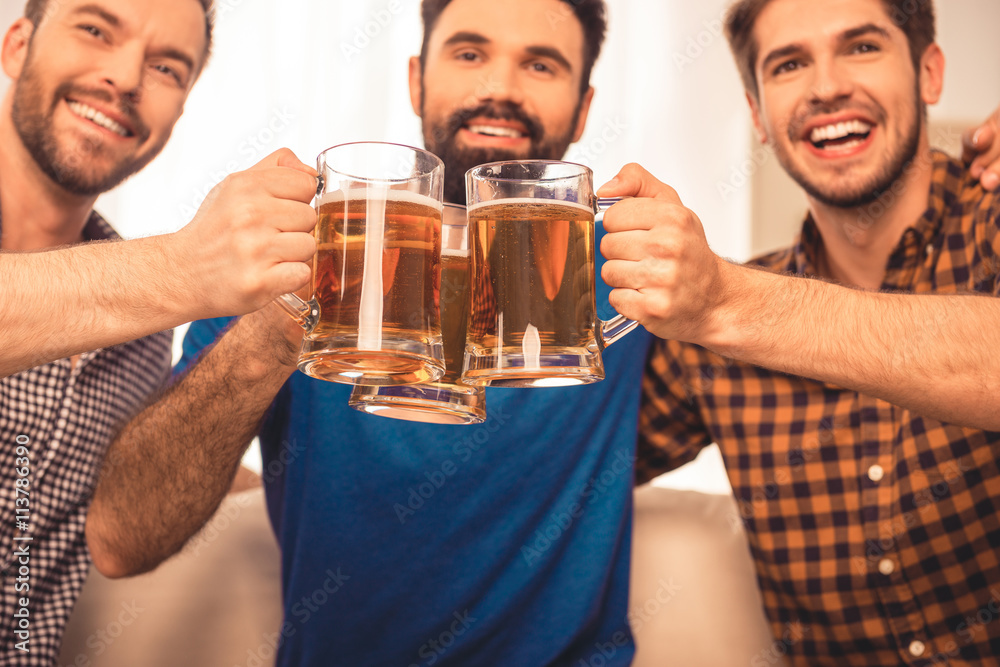 cheers! Close up photo of handsome men celebrating and clinking cheers! Close up photo of handsome men celebrating and clinking