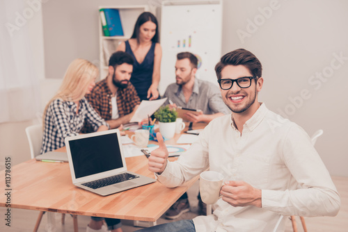 handsome businessman sitting with glasses and cup at conference