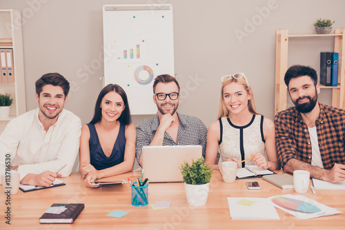 photo of  happy young team of  businesspeople sitting at confere photo