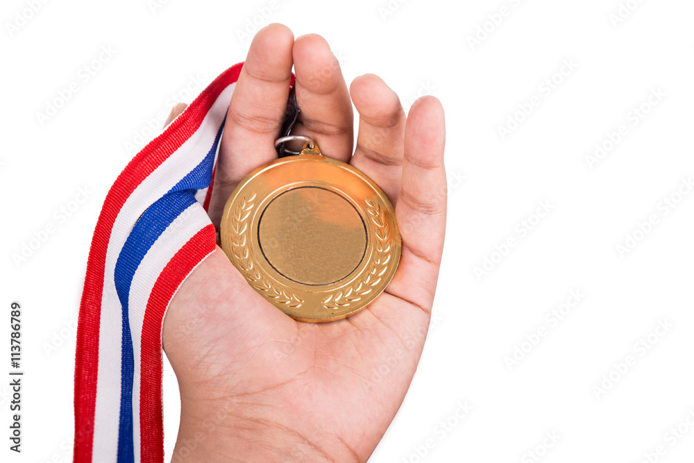 Fototapeta premium Athlete holding generic gold medal with ribbon on his hand