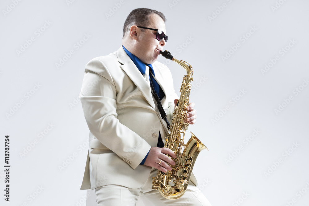 Fototapeta premium Portrait of Expressive Stylish Caucasian Saxophone Player Performing in Studio Environment