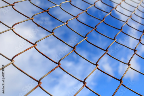 iron wire fence on blue sky background