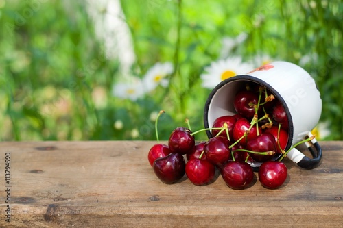 cherries sprinkled on a bench in the village.selective focus