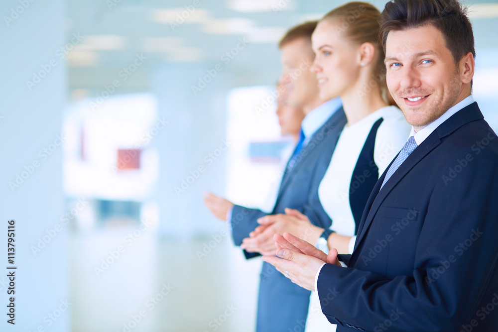 Smiling business people applauding a good presentation in the office Smiling business people applauding a good presentation in the office